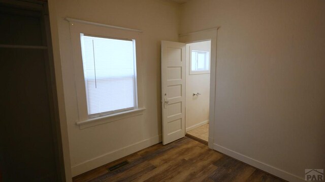 1434 E Evans Ave, Pueblo, CO 81004 - unfurnished bedroom featuring multiple windows, baseboards, and visible vents