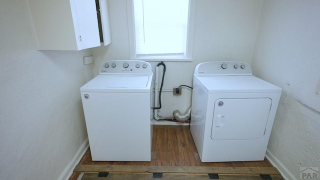 1434 E Evans Ave, Pueblo, CO 81004 - washroom with wood finished floors, washer and clothes dryer, and cabinet space