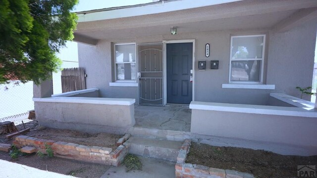 1434 E Evans Ave, Pueblo, CO 81004 - property entrance featuring stucco siding and fence