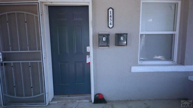 1434 E Evans Ave, Pueblo, CO 81004 - view of exterior entry featuring stucco siding
