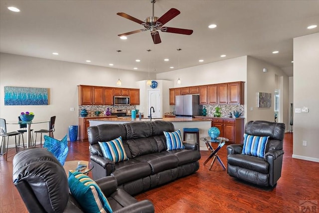 living area with ceiling fan, dark wood-style flooring, and recessed lighting