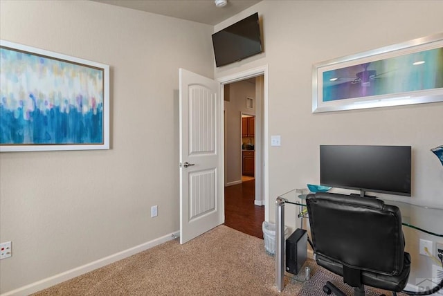 carpeted home office with baseboards