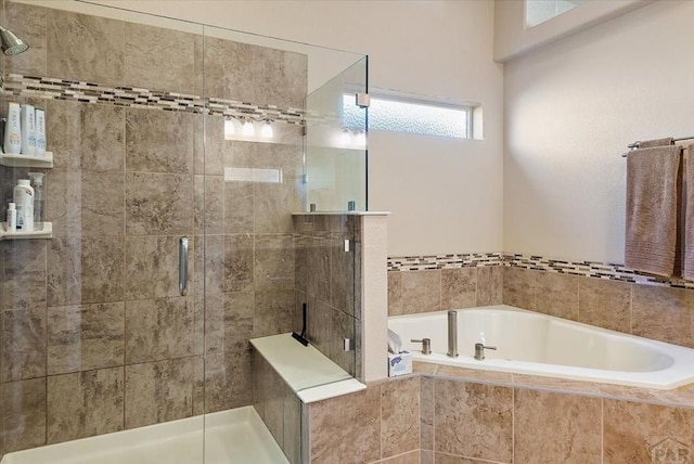 bathroom with a stall shower and a bath