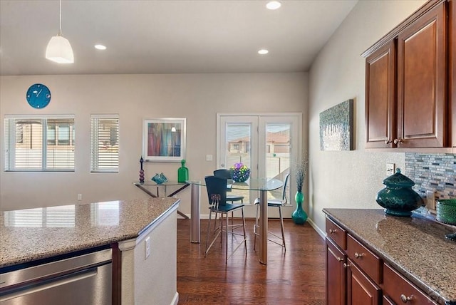 kitchen featuring plenty of natural light, hanging light fixtures, and light stone countertops