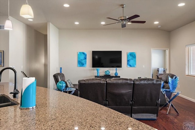 living area featuring baseboards, ceiling fan, dark wood-type flooring, vaulted ceiling, and recessed lighting