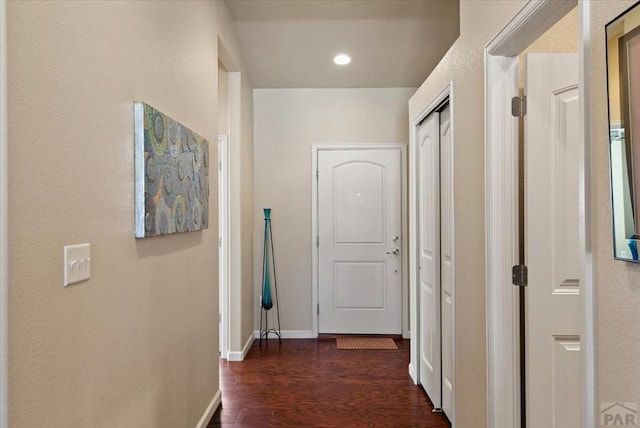 hall with baseboards, dark wood-type flooring, and recessed lighting