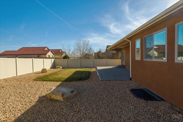 view of yard with a patio and a fenced backyard