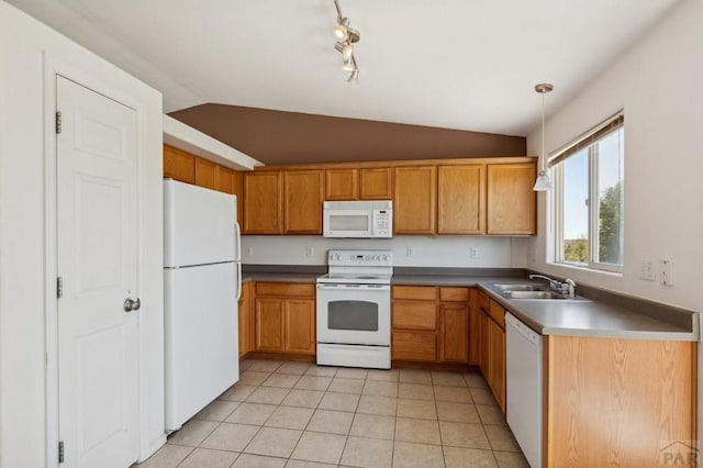 8718 Silver Glen Dr, Fountain, CO 80817 - kitchen with white appliances, lofted ceiling, light tile patterned floors, hanging light fixtures, and rail lighting
