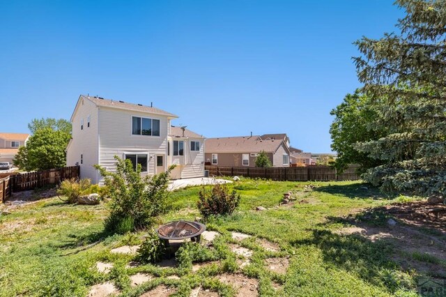 8718 Silver Glen Dr, Fountain, CO 80817 - back of property featuring an outdoor fire pit and a fenced backyard