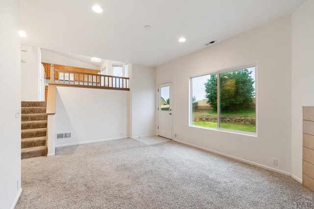 8718 Silver Glen Dr, Fountain, CO 80817 - unfurnished living room featuring light carpet, stairs, and recessed lighting