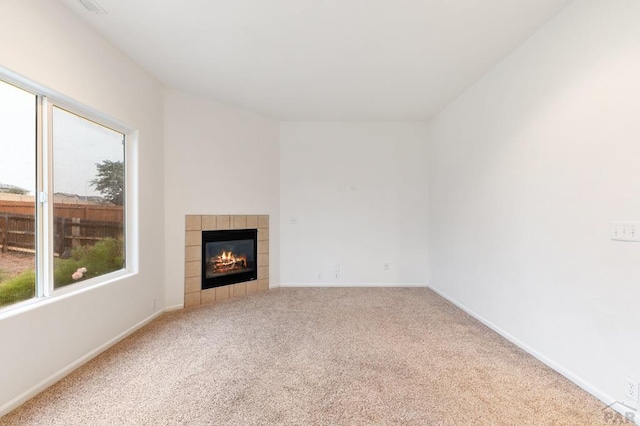 8718 Silver Glen Dr, Fountain, CO 80817 - unfurnished living room featuring carpet floors and a tiled fireplace