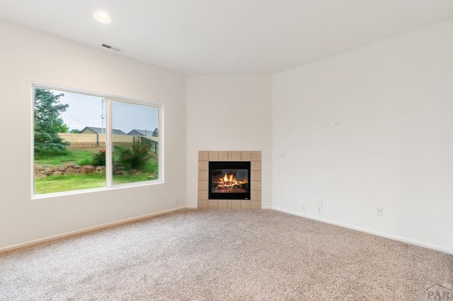 8718 Silver Glen Dr, Fountain, CO 80817 - unfurnished living room with carpet floors and a tiled fireplace