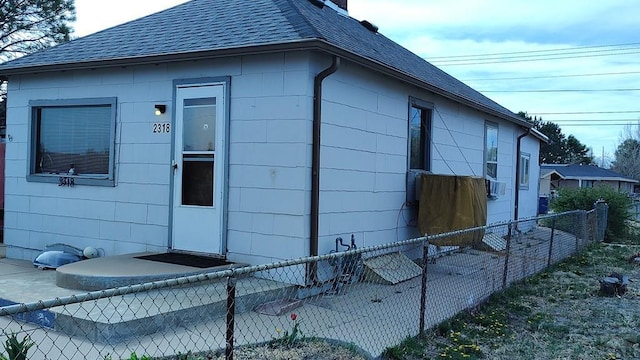 2318 W 17th St, Pueblo, CO 81003 - view of side of home with a shingled roof, fence, and a chimney