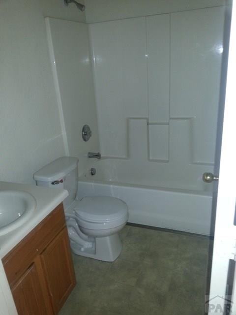 full bathroom featuring tub / shower combination, vanity, and toilet