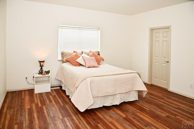 bedroom with dark wood finished floors