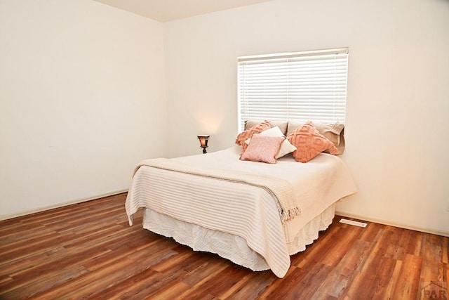 bedroom featuring dark wood-style flooring