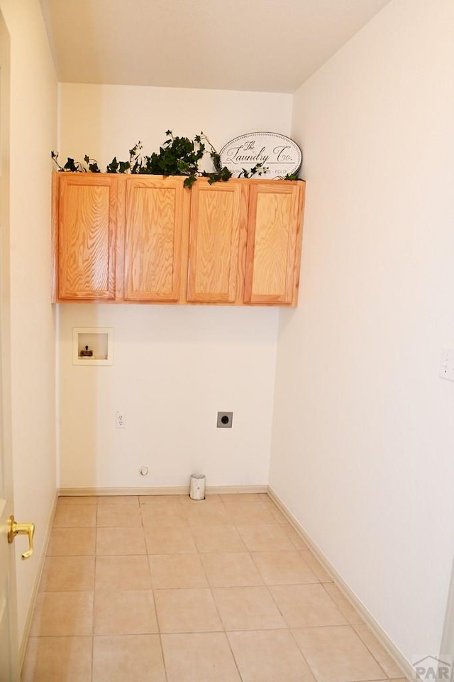 laundry area featuring cabinet space, light tile patterned floors, hookup for a gas dryer, washer hookup, and electric dryer hookup