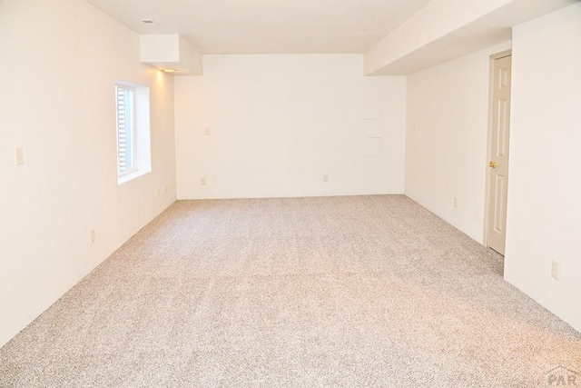 unfurnished room with light carpet