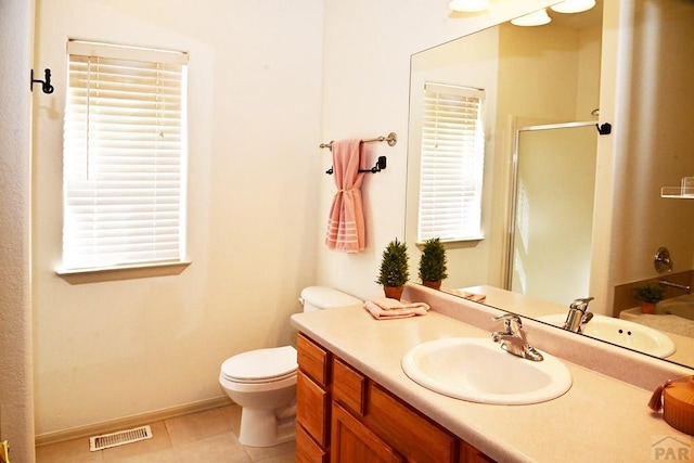 full bath featuring visible vents, toilet, a shower with shower door, vanity, and tile patterned flooring