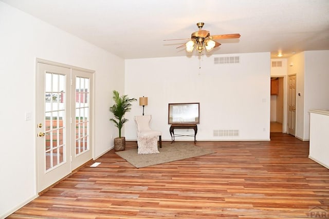 sitting room featuring ceiling fan, visible vents, and light wood-style floors