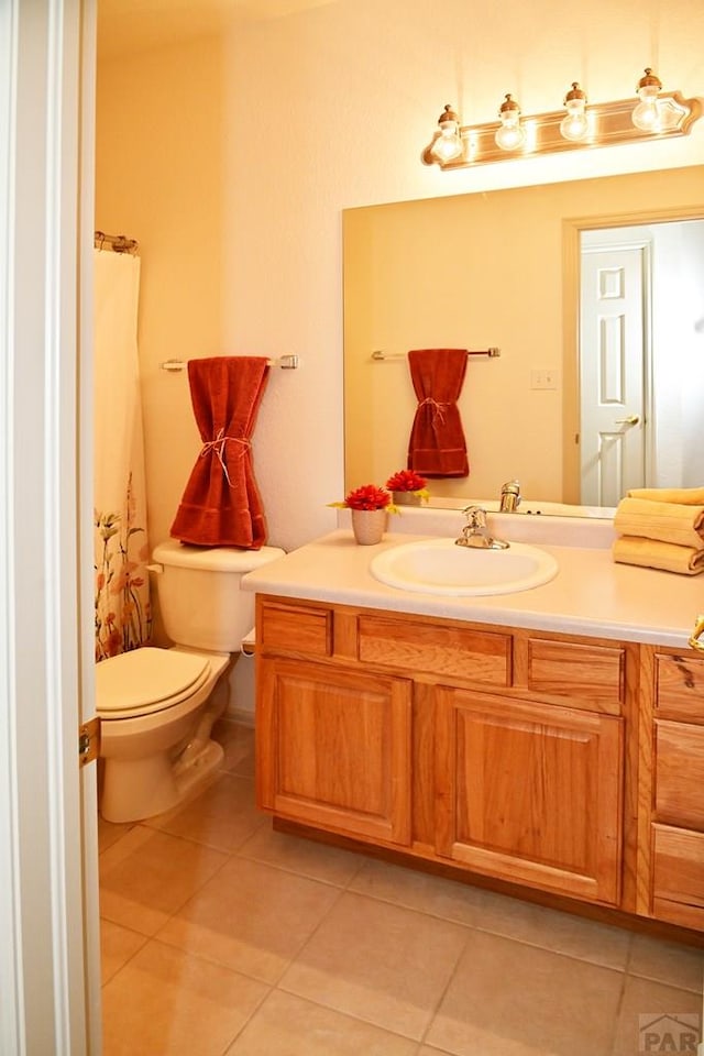 full bath featuring toilet, tile patterned flooring, and vanity