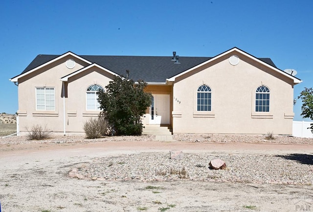 ranch-style house featuring stucco siding