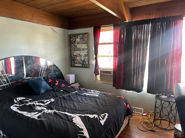 bedroom featuring cooling unit, wood ceiling, beamed ceiling, and wood finished floors