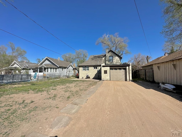 exterior space with driveway and fence