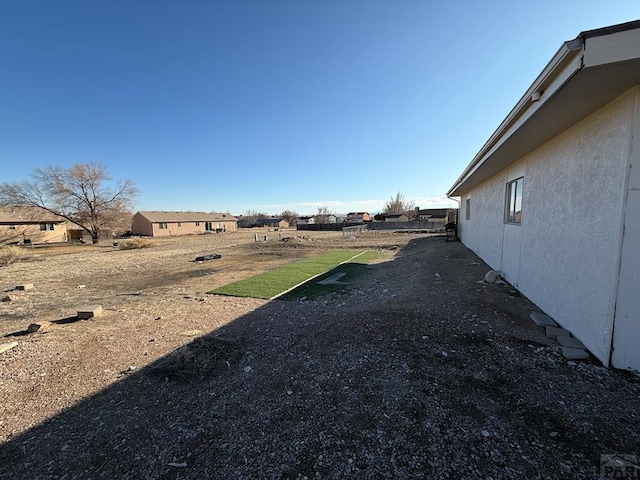 view of yard with a residential view and fence