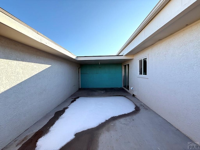 exterior space with a patio and stucco siding