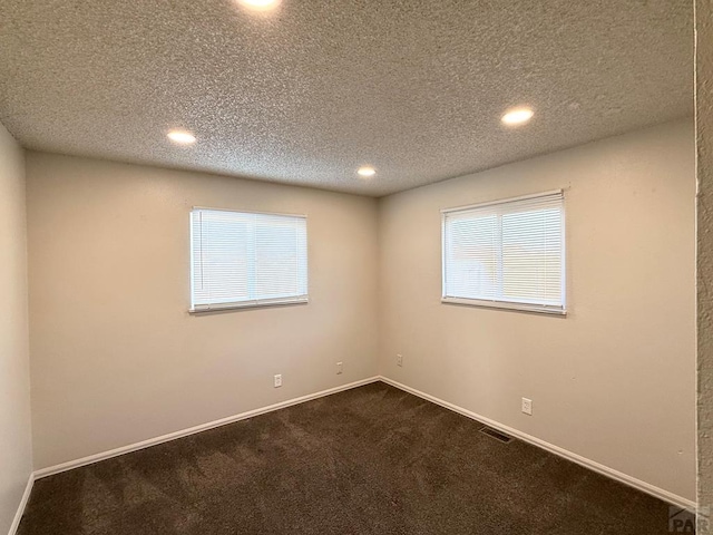 unfurnished room with baseboards, visible vents, carpet flooring, and recessed lighting