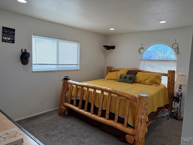 bedroom featuring dark colored carpet, a textured ceiling, baseboards, and recessed lighting