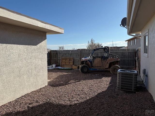 view of yard with cooling unit and fence