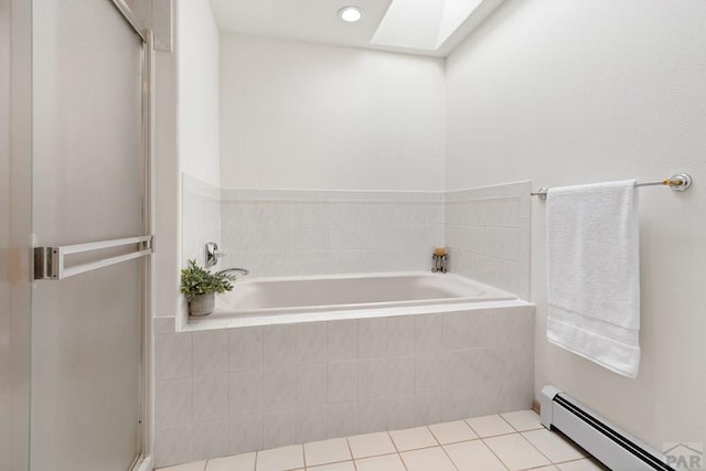 full bath featuring a garden tub, a stall shower, a skylight, tile patterned floors, and a baseboard radiator