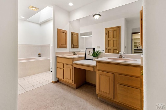 full bathroom with an enclosed shower, a garden tub, a skylight, tile patterned flooring, and vanity