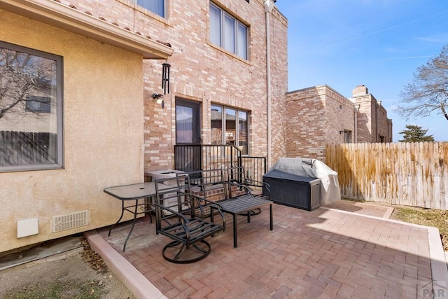 view of patio featuring fence and visible vents