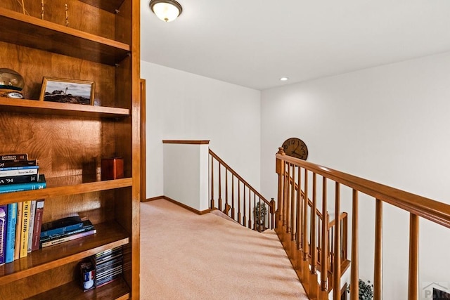 hall featuring an upstairs landing, recessed lighting, baseboards, and carpet floors