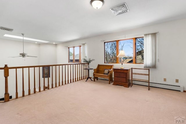 sitting room with baseboard heating, carpet flooring, and visible vents