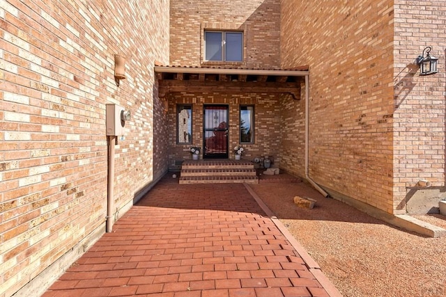 property entrance with brick siding