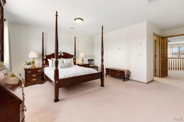 bedroom featuring baseboards and light carpet