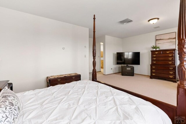 bedroom with visible vents and carpet floors