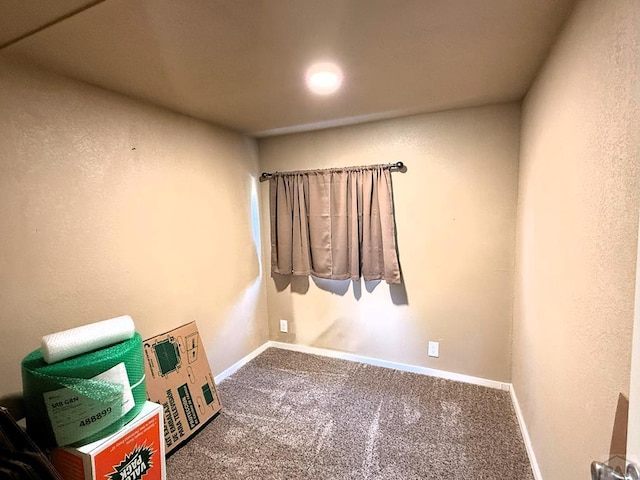 carpeted empty room with baseboards