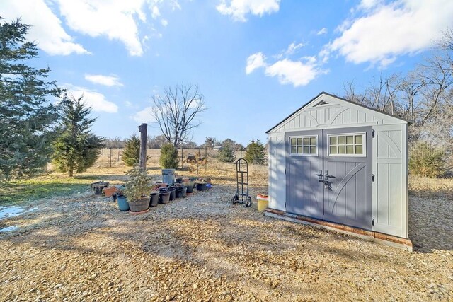 view of shed with a rural view