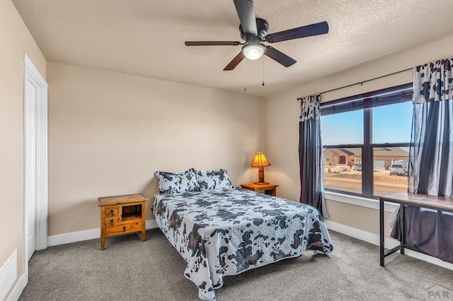 1216 N Whitetail Pl, Pueblo, CO 81007 - bedroom with carpet, baseboards, a ceiling fan, and a textured ceiling