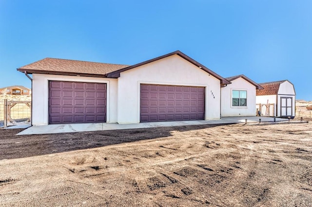 view of front of property featuring a garage and stucco siding