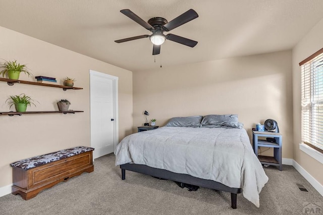 bedroom featuring baseboards, visible vents, ceiling fan, and light colored carpet