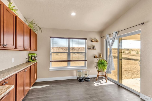 interior space with a textured ceiling, dark wood-style flooring, recessed lighting, and baseboards