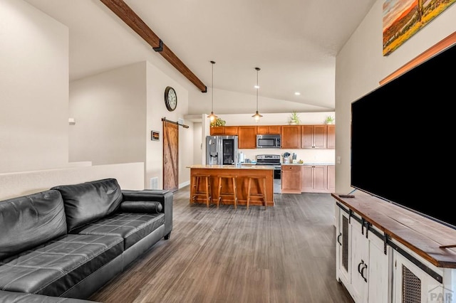 living area featuring high vaulted ceiling, a barn door, dark wood-type flooring, and beam ceiling