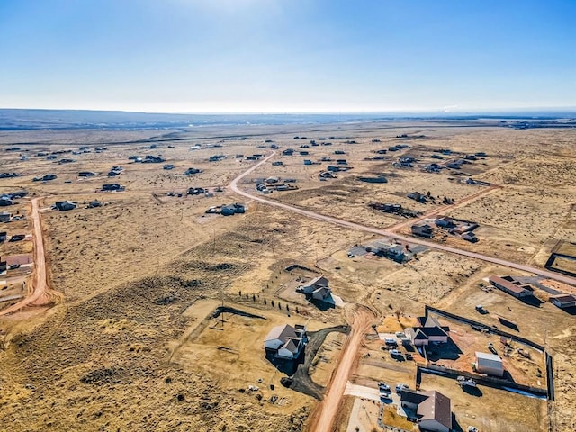 birds eye view of property with a desert view and a rural view