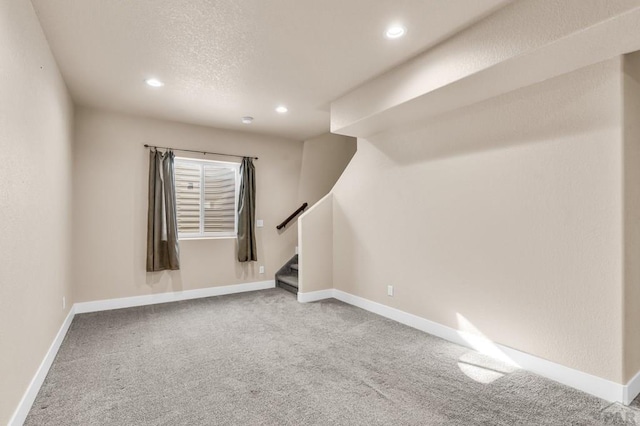 basement with carpet, stairway, and baseboards